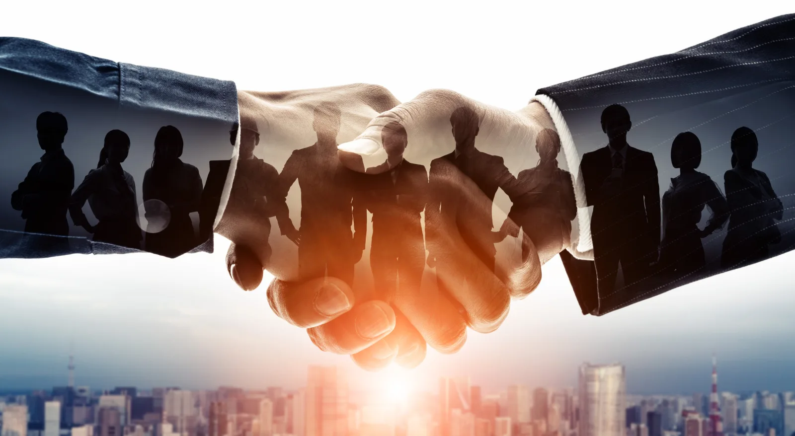 Two parties shaking hands to close a transaction